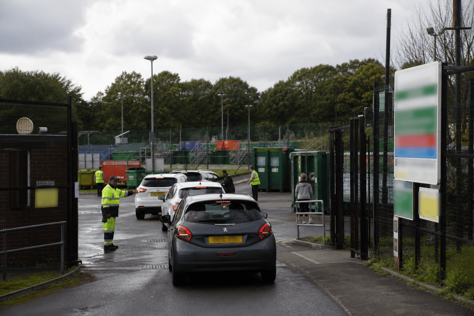 Cars queuing at a UK household waste recycling centre